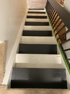 the stairs are painted black and white with green trim