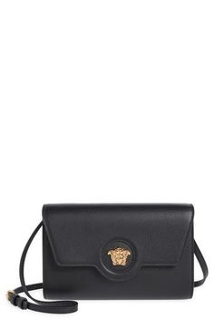 A signature Medusa head—based on the molded door of Versace's first headquarters—stands out on a leather wallet that doubles as a clutch or shoulder bag. Magnetic-snap flap closure Removable, adjustable shoulder strap Interior zip and wall pockets; six card slots Twill lining Leather Made in Italy Designer Handbags Evening Leather Wallets With Gold-tone Logo Plaque, Formal Leather Wallet On Chain With Logo Plaque, Classic Evening Wallet On Chain With Logo Plaque, Luxury Black Wallet On Chain With Gold-tone Logo, Formal Black Wallet On Chain With Gold-tone Logo, Classic Formal Wallet On Chain With Logo Plaque, Elegant Evening Wallet On Chain With Logo Plaque, Luxury Formal Wallet On Chain With Logo Plaque, Designer Evening Wallets With Logo Plaque