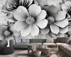 a living room with large flowers on the wall