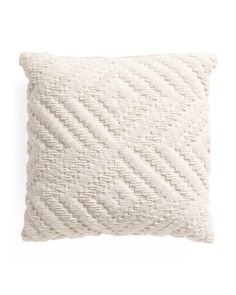 a white pillow that is made from cotton and has a braided design on the front