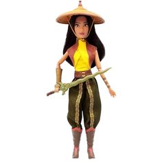 the doll is wearing a straw hat and green pants