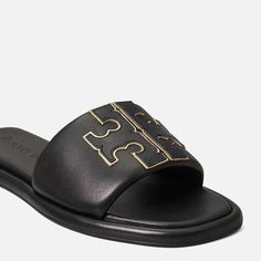 Comfortable and versatile, you'll reach for Tory Burch's slide sandals often. They're made from padded leather that hugs the foot and have a cushioned foam insole for extra support. The raised 'Double T' is traced with a gold-tone trim for subtle shine. Tan Leather Open Toe Flip Flops, Tan Open Toe Slides With Removable Insole, Tan Leather Open Toe Slides, Flat Tan Sandals With Leather Footbed, Leather Slides In Tan For Summer, Summer Tan Leather Slides, Tan Open Toe Sandals With Cushioned Footbed, Tan Synthetic Open Toe Sandals, Tory Burch Slides