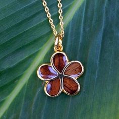 This 14k gold vermeil pendant features our original Koa wood plumeria motif. Each piece may vary slightly in color Plumerias are beautiful flowers that are prevalent in Hawaiian culture. Plumerias symbolize love, beauty, and commitment, often used in romantic occasions and weddings. It is also associated with spiritual growth and transformation, representing inner peace and the ability to overcome obstacles.  **All orders come with a jewelry box, and polishing cloth. Hawaiian Culture, Koa Wood, Spiritual Growth, Inner Peace, Gold Vermeil, Pendant Necklaces, Beautiful Flowers, Jewelry Necklace Pendant, Jewelry Box