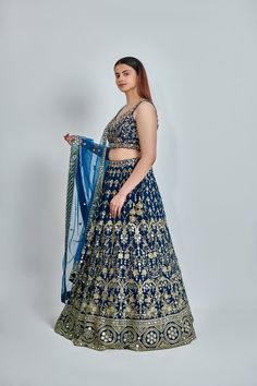 ABOUT Blue lehenga with all-over zari, dabka & nakshi work. Paired with a padded embroidered blouse and mirror work border dupatta. No of Components: 3 Components: Blouse, Dupatta, Lehenga Pattern: Embroidered Type of Work: Dabka, Nakshi, Zari Neckline: Sweetheart Sleeve Type: Sleeveless Fabric: Georgette Color: Blue Embroidered dupatta Please note: Originally stitched in size 36 but can be altered for size 34 without any extra cost. Diwali Embroidered Semi-stitched Lehenga, Festive Bollywood Embroidered Lehenga, Floor-length Embroidered Choli For Diwali, Fitted Traditional Lehenga With Resham Embroidery, Diwali Semi-stitched Choli With Intricate Embroidery, Anarkali Choli With Intricate Embroidery For Diwali, Anarkali Embroidered Choli For Diwali, Bollywood Style Meenakari Lehenga For Reception, Bollywood Meenakari Lehenga For Reception