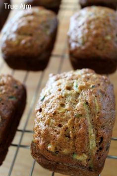 zucchini muffins cooling on a wire rack with the words true am above them