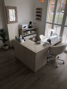 a room with a desk, chair and window in the corner that has shutters on both sides