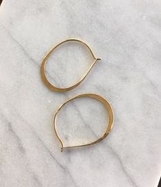 These uniquely oval shaped hoop earrings are lightly hammered and have an interlocking closure. I hammer each one of these earrings into shape and forge them by my hand, in my studio, adding a nice shimmer when they hit the light. Very lightweight hoops, that are great for everyday wear. The part of the earring that slides through the earlobe is slightly thinner then the rest of the hoop, for a very comfortable fit, the normal sizing of most earring posts.MEASUREMENTS: (Shown in pictures)length Modern Oval Hoop Earring Sold Individually, Modern Oval Hoop Earrings With Ear Wire, Everyday Hammered Oval Jewelry, Everyday Oval Hammered Jewelry, Oval Nickel-free Hoop Earrings For Everyday Wear, Nickel-free Oval Hoop Earrings For Everyday, Oval Single Earring For Everyday, Everyday Oval Nickel-free Hoop Earrings, Minimalist Handmade Oval Hoop Earrings