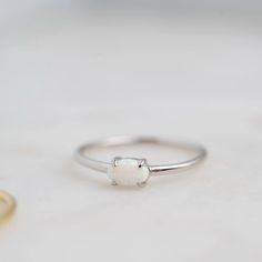 Made of Sterling Silver 14K Gold or Rhodium plating Nickel-free & Hypoallergenic Highest grade lab created opals Available in sizes 4-10 White Opal Birthstone Ring In 14k Gold, 14k Gold White Opal Birthstone Ring, White Opal Birthstone Ring With Gemstone, White Opal Dainty Birthstone Ring, White Dainty Opal Gemstone Ring, White Dainty Opal Ring, White Dainty Opal Birthstone Ring, White Opal Birthstone Ring In Dainty Style, Classic Opal Moonstone Ring As Gift