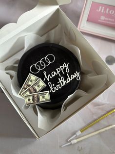 a birthday cake in a box with money