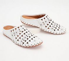 A geometric cutout design gives these leather mules a light and airy feel with breathable comfort for your feet. From Spring Step. Modern Summer Slip-ons With Leather Sole, Spring Flat Heel Slip-ons With Perforations, White Flat Heel Clogs For Summer, White Slip-ons With Perforated Toe Box, White Flat Heel Clogs For Spring, White Spring Clogs With Flat Heel, Comfortable Flat Heel Spring Mules, White Leather Slip-on Clogs, White Flat Clogs For Spring