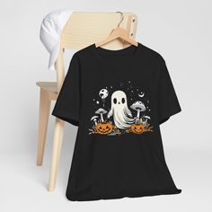 Embrace the magic of the season with our enchanting collection of Halloween tees! From spooky-chic to cottagecore dreams, we've got the perfect top to elevate your autumnal wardrobe. Spooky Halloween Pumpkin Ghost T-Shirt to channel your inner free spirit with this ethereal design. A playful ghost, adorned with bohemian patterns, dances across a soft, cozy fabric. Perfect for layering over jeans or a flowy skirt, this tee is a must-have for those who love a touch of whimsy. Trick or Treat Cottag Fall Goblincore Crew Neck T-shirt, Fairy Grunge Halloween Crew Neck Top, Fairy Grunge Crew Neck Top For Halloween, Goblincore Crew Neck T-shirt For Fall, Witchy Halloween T-shirt With Graphic Print, Halloween Fairy Grunge T-shirt With Crew Neck, Halloween Fairy Grunge Tops, Fairy Grunge Halloween T-shirt With Crew Neck, Fall Witchy Graphic Print T-shirt