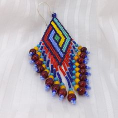 Seed bead earrings, 3 1/8 inch (8cm) drops, beaded fringe earrings, red blue yellow and green glass beads, dramatic jewelry. $45.00, via Etsy. Traditional Multicolor Beaded Fringe Tassel Earrings, Traditional Multicolor Beaded Tassel Earrings, Traditional Handwoven Blue Beaded Earrings, Traditional Blue Handwoven Beaded Earrings, Artisan Multicolor Beaded Tassel Earrings, Artisan Multicolor Beads With Beaded Fringe, Artisan Multicolor Beaded Earrings, Multicolor Handwoven Tassel Earrings Gift, Multicolor Handwoven Drop Tassel Earrings