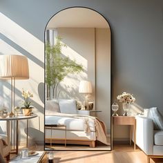 a bedroom with a large mirror on the wall next to a couch and coffee table