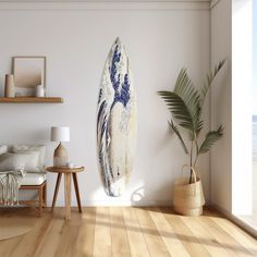 a living room with a surfboard on the wall next to a chair and table