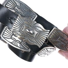 39"-42" Vintage Southwestern sterling concho belt. Stamped sterling, illegible
signature, likely Native American made. (1) 2 1/8" x 1.25" buckle, (10) 2 1/8" x
1 1/8" conchos. All sterling with copper backs. 321.3 grams. Existing holes at
39"-42", 1" leather. Artisan Adjustable Concho Belts, Adjustable Southwestern Concho Belt Buckles, Black Southwestern Concho Jewelry, Silver Southwestern Concho Belt, Vintage Silver Concho Belt, Concho Belt, American Made, Austin Tx, Native American