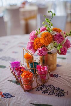 an arrangement of flowers in vases on a table