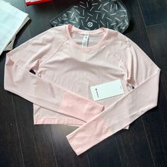 Brand New Tags Lululemon Swiftly Tech Cropped Long Sleeve 2.0 Color Strawberry Milkshake (Stmi/Stmi) Size 10 Please Note I Do Not Accept/Respond To Low Ball Offers Reasonable Offers Only Please And Thank You Guaranteed Authentic 5 Star Top Rated Seller Next Day Shipping G836 Pink Sporty Activewear With Thumbholes, Spring Activewear With Thumbholes For Sports, Pink Long Sleeve Activewear For Light Exercise, Pink Long Sleeve Activewear For Workout, Pink Activewear With Thumbholes For Sports, Lulu Fits, Lululemon Shirt, Color Outfits, Athletic Clothes