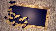 a black and gold frame with the words callis chapman jones on it next to a pair of scissors