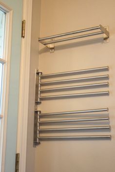 a towel rack in the corner of a bathroom