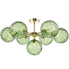 a green glass chandelier with five lights on each end and four balls hanging from the ceiling