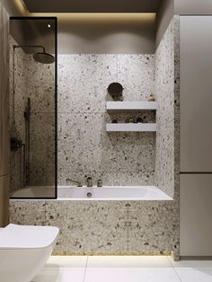 a bathroom with a bathtub, toilet and sink in it's center area