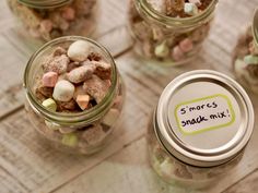 small jars filled with marshmallows and s'mores