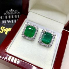 "BRAND-NEW!! ONE OF A KIND, HANDCRAFTED EARRINGS. So Perfect Jewelry proudly presents!! Delicately handcrafted, EXQUISITE EMERALD EARRINGS! With two matching HUGE NATURAL Emeralds! TOP VIVID GREEN COLOR AND FULL TRANSPARENCY with few minor inclusions. Accented with superb quality, natural diamonds, set in handcrafted 18K solid white gold earrings. Classy and simple, elegant and charming, with vivacious Green COLOR, and sparkling diamonds, these earrings sure make a lady feel like a princess! \"Y Luxury Diamond Earrings With Halo Setting, Green Diamond Earrings With Halo Setting Gift, Emerald Cut Earrings With Halo Setting For Anniversary, 14k White Gold Halo Diamond Earrings For Gift, Emerald Cut Halo Setting Earrings For Anniversary, Gia Certified Green Diamond Earrings Gift, White Gold Emerald Earrings With Halo Setting, Emerald Cut Halo Setting Earrings For Wedding, Emerald Cut Halo Setting Wedding Earrings