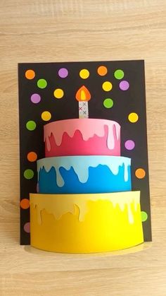 three colorful birthday cakes on top of each other