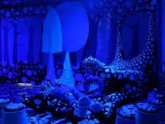 a room filled with lots of different types of furniture and decorations in blue lighting,