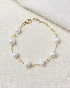 An ageless classic, this white freshwater pearl station bracelet is sure to become a go-to staple in any jewelry collection. Gleaming cultured pearls on a textured, open-link chain give this piece an effortless, graceful allure. Bracelet length: 7 inches plus 1 inch extender Materials: gold fill, cultured freshwater pearls Affordable Elegant Pearl Drop Bracelet, Elegant Pearl Drop Chain Bracelet, Classic White Chain Bracelet For Everyday, Elegant Pearl Chain Bracelet With Pearl Drop, Classic Pearl Bracelets With Adjustable Chain, White Pearl Bracelet With Chain Detail, Classic White Chain Bracelet With Pearl Drop, White Pearl Bracelet With Chain, Elegant White Chain Bracelet With Pearl Drop