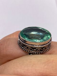 Large brilliant emerald green antique glass  Ornate German Silver  NOT 925  Vintage ring, does not tarnish Size 7.5 can be re sized, my jeweler charges a $20 fee All rings are shipped free in the US in a nice gift box.   Check out our over a THOUSAND great reviews Engraving is $4 per letter and is not always perfect depending on the piece. It can take a few days if the jeweler is busy. This is payable to Paypal Judithsltd@gmail.com Green Sterling Silver Topaz Ring, Green Oval Topaz Ring In Sterling Silver, Antique Emerald Ring For Gift, Antique Emerald Ring As A Gift, Green Crystal Ring With Large Stone For Gift, Green Oval Crystal Ring In Sterling Silver, Oval Green Crystal Sterling Silver Ring, Silver Oval Crystal Ring For May Birthstone, Unique Faceted Green Jewelry