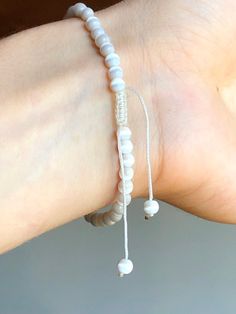 These beautiful bracelets are so dainty, versatile, durable, and adjustable. Easy to put on and off, slide the dangles and macrame closure for the perfect fit. All vintage natural white cats eye stones. Perfect for the beach! Bracelet adjustable 5.5 - 8 inches Comes in gift box Vintage Beaded Bracelet Adjustable Macrame Natural White Cats Eye Stones Beaded Bracelet with Dangles Adjustable Spiritual Friendship Bracelets With Sliding Knot, Adjustable Spiritual Friendship Bracelet With Sliding Knot, Adjustable Macrame Beaded Bracelets For Friendship, Adjustable Macrame Beaded Friendship Bracelets, Adjustable Hand-strung Spiritual Friendship Bracelets, Spiritual Adjustable Beaded Bracelets With Sliding Knot, White Beaded Bracelets With Adjustable Cord, White Adjustable Cord Friendship Bracelets, Adjustable Spiritual Hand-strung Friendship Bracelets