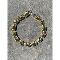 A stunning 7.5" bracelet featuring 14 green jade filigree stones paired with 28 white crystals, all set in a gold-tone metal with a fold-over clasp.  * Gold-tone metal material  * 14 green jade filigree stones  * 28 white set crystals  * Fold-over clasp  * Measures 7.5" in length Condition: Pre-Owned See Photos for Details Good Thank you for Visiting My Etsy Shop! Bohemian Green Jade Bracelets, Gold Jade Crystal Round Bracelet, Bohemian Green Jade Bracelet, Spiritual Green Jade Crystal Bracelet, Gold Jade Crystal Bracelet, Spiritual Style, White Crystals, Crystal Set, White Crystal, Jade Green