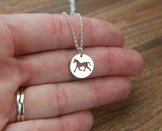 Horse charm necklace in sterling silver, equestrian, western jewelry, horse pendant, animal charm This cute little sterling silver horse charm (0.51 inches) is attached to a sterling silver chain that can be any length up to 22 inches and secured with a sterling silver spring clasp. Perfect with any outfit! Your purchase will arrive in a jewelry box ready for gift giving or as a gift for yourself! Enter my shop here: jersey608jewelry.etsy.com Thanks for looking! Raquel Horse Design Round Pendant Necklace As Gift, Horse Design Round Pendant Necklace For Gift, Adjustable Sterling Silver Horse Design Jewelry, Round Pendant Necklace With Horse Design For Gift, Silver Sterling Silver Jewelry For Shows, Silver Horseshoe Charms Jewelry, Horseshoe Shaped Sterling Silver Necklaces, Silver Sterling Silver Horseshoe Necklace, Personalized Silver Horseshoe Jewelry