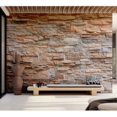 a living room with stone walls and furniture