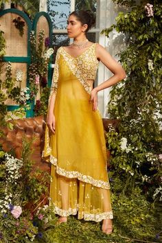 Yellow floral embroidered one shoulder cape. Paired with embroidered kurta and sharara.
Components:3
Pattern:Embroidered
Type of Work:Thread work, Sequins
Neckline:V neck
Sleeve Length:Sleeveless
Fabric:Net, Organza
Color:Yellow
Other Details:
Sheer sharara
Sequin work detail
Occasion:Party, Reception - Aza Fashions Cape Sharara, Haldi Outfits, Embroidered Cape, Haldi Outfit, Indo Western Dress, Western Dress, Amritsar, Sharara Set, Indo Western