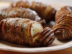 some potatoes are sitting on a white plate