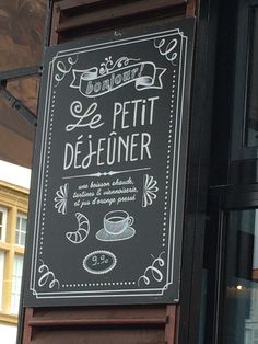 a sign on the side of a building that says le petit dejeuner