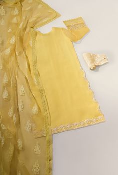 Adorned on pure cotton net, in a pastel yellow hue with intricate single thread ivory embroidery alongside clusters of pearls on kameez and trousers. The length of the long kameez is 43 inches. The pure organza dupatta features offwhite hand block print motifs with pretty lace edging. Order Duration: 4 to 6 weeks Yellow Unstitched Suit With Naqshi Detail, Yellow Organza Dupatta With Floral Embroidery, Yellow Embroidered Summer Dupatta, Yellow Organza Dupatta, Yellow Embroidered Organza Dupatta, Loafer Shoes Women, Bridal Dresses Pakistan, Organza Dupatta, Nude Color