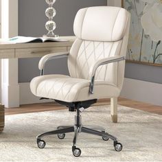 a white office chair sitting on top of a rug in front of a wooden table