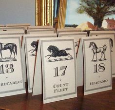 four greeting cards with horses on them sitting on a table