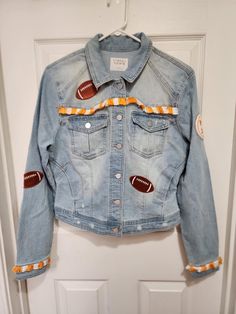 Gotcha some white cowgirl boots? This jacket will be perfect with it! Just in time for cooler football night games! One of a kind lady's junior boutique denim jacket hand fringed in orange and white. Cropped, faded, distressed and patched with footballs. All sales final. Football Jean Jacket, Tennessee Game Day, Football Night, White Cowgirl Boots, Night Games, Senior Ideas, Knoxville Tn, Ladies Boutique, Cowgirl Boots