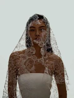 a woman wearing a veil with flowers on it