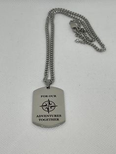 a dog tag that says for our adventures together