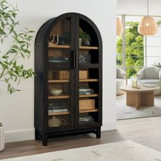 an arched bookcase with baskets and books on it in a living room next to a potted plant