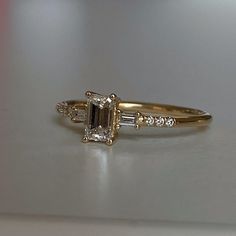 an engagement ring with two baguettes on the side