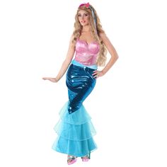 a woman dressed in a blue and pink mermaid costume with her hands on her hips