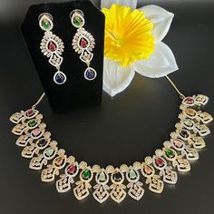 Glamorous sleek design, a multi color set with gold base! Premium quality AD cut and cubic zirconia Festive Multicolor Gold Plated Jewelry Sets, Festive Multicolor Gold-plated Jewelry Sets, Multicolor Gold Plated Bollywood Jewelry, Elegant Multicolor Party Sets, Multicolor Hand Set Festive Sets, Festive Multicolor Hand Set Sets, Festive Multicolor Hand Set, Multicolor Gold-plated Jewelry Sets For Gifts, Multicolor Multi-stone Jewelry Sets For Wedding