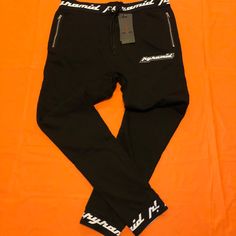 Black Pyramid Sweatpants Fitted Black Urban Sweatpants, Black Fitted Urban Sweatpants, Fitted Black Joggers With Side Pockets, Black Tapered Leg Sweatpants For Streetwear, Black Athleisure Bottoms With Tapered Leg, Black Tapered Leg Athleisure Bottoms, Black Tapered Leg Sweatpants, Urban Black Tapered Leg Joggers, Black Stretch Urban Joggers