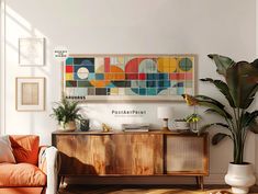 a living room filled with furniture and plants on top of a hard wood floored floor